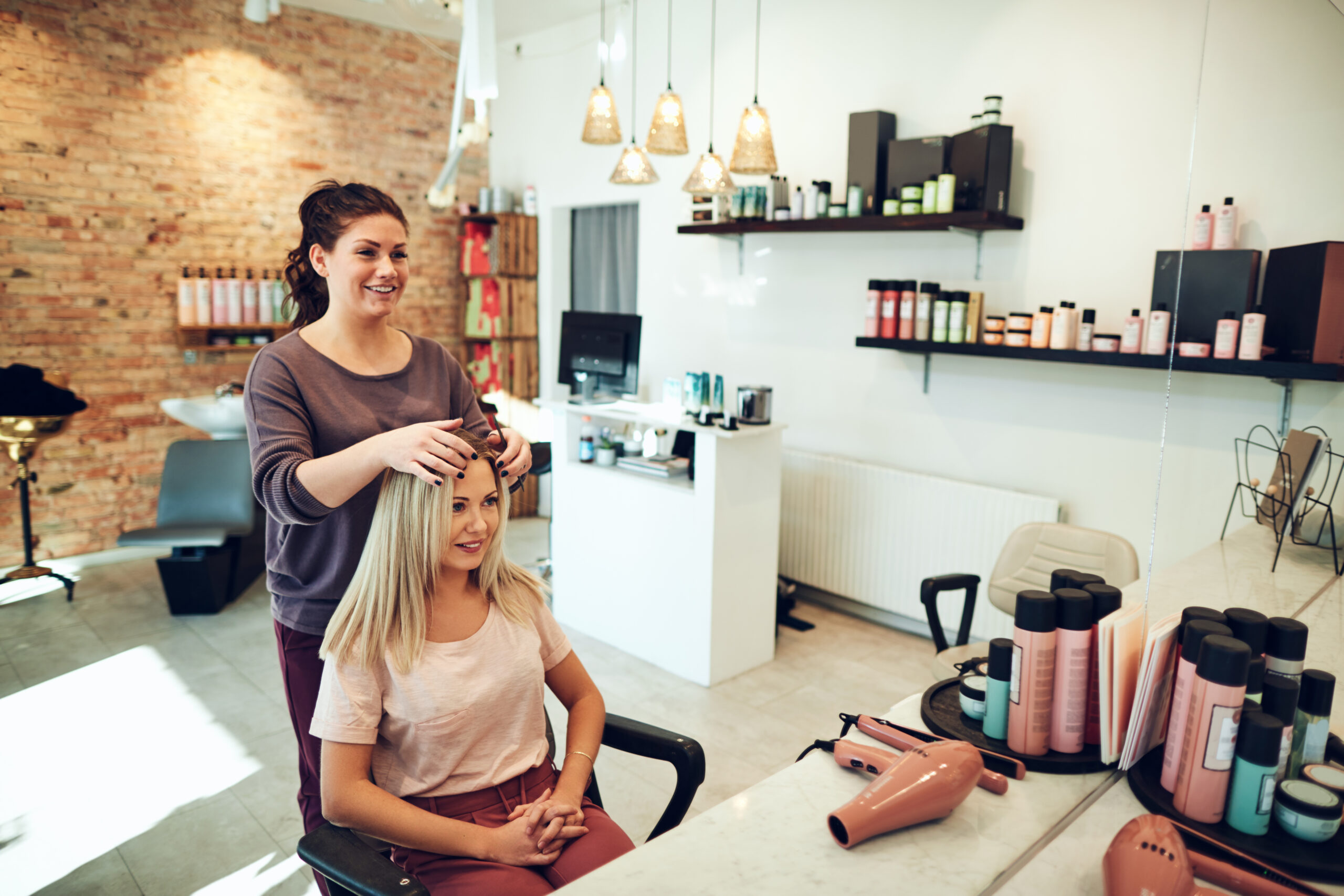 Young woman talking with her hairstylist during a salon appointm